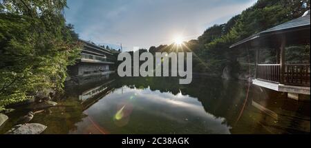 Hexagonal Pavillon Ukimido im zentralen Teich des Mejiro Garden, wo Enten ruhen und die s ist Stockfoto