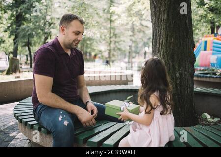 Kleines Mädchen, das Geschenk von ihrem Vater erhält Stockfoto