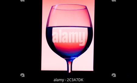 Glas oder Gläser mit Alkohol, Wein, Whisky, Gin, Bier, Rum, Wodka, Whisky, Cognac, Brandy, Likör, Absinth oder Cocktail auf rosa Hintergrund. Ein Glas an der Bar Stockfoto