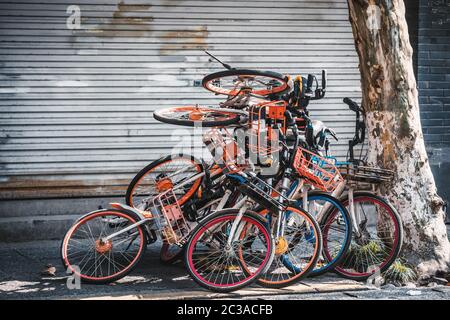 Haufen zerbrochener Elektrofahrräder auf dem Bürgersteig, Hangzhou, China Stockfoto