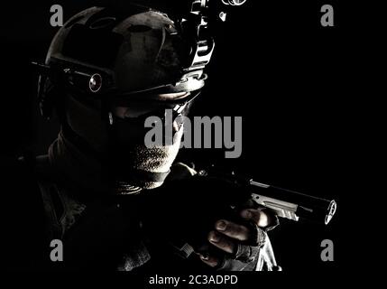 Armee-Terrorismusbekämpfung-Trupp, Polizei-SWAT-Team-Kämpfer versteckt Identität hinter Maske und Brille, trägt Helm mit Nachtsichtgerät, kriecht in d Stockfoto