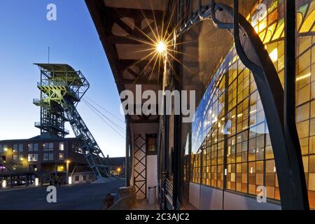 Beleuchtete Maschinenhalle mit Kopfrahmen bei Dämmerung, Zeche Zollern, Dortmund, Deutschland, Europa Stockfoto