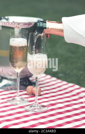 Champagner gegossen wird bei einem Sommerpicknick Stockfoto