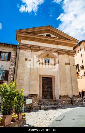 1. Juni 2019 - Spello, Perugia, Umbrien, Italien - EINE Kirche mit einem Tympanon und einer Holztür im historischen Zentrum. Stockfoto