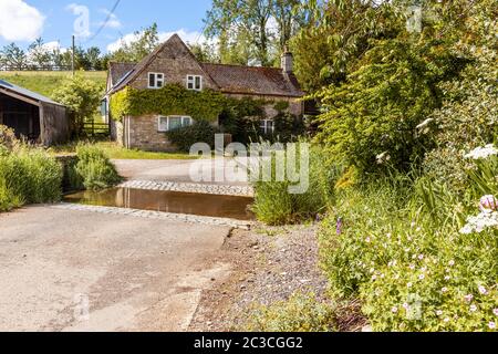 Ein Ferienhaus an der ford im Cotswold Dorf von Middle Duntisbourne, Gloucestershire Großbritannien Stockfoto