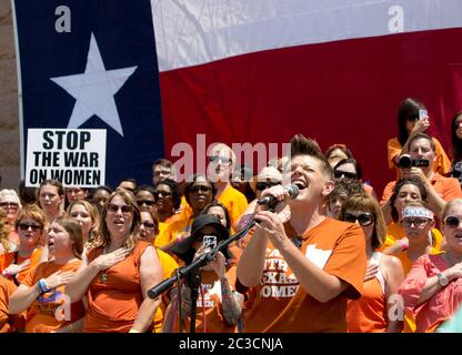 1. Juli 2013 Austin, Texas, USA: Eine junge Frau mit einem Trikot aus Texas singt die Nationalhymne vor einer Menge von Befürwortern der Wahl bei einer Kundgebung vor dem Texas Capitol vor dem Beginn einer zweiten Sondersitzung der Legislative, die umstrittene Beschränkungen des Zugangs von Frauen zu Abtreibungen erörtern soll. ©Bob Daemmrich Stockfoto