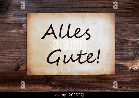 Altes Grünpapier Mit Deutschem Text Alles Gute Bedeutet Beste Wünsche. Holzhintergrund Stockfoto