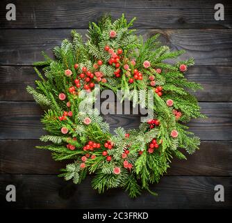 Weihnachtskranz auf dunklem Holzhintergrund Stockfoto