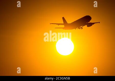 Passagierflugzeug ist während eines wunderbaren Sonnenaufgangs starten Stockfoto