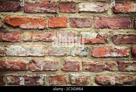 Alte rote Backstein Hintergrund. Cross-verarbeitet und mit zusätzlicher Vignette. Stockfoto