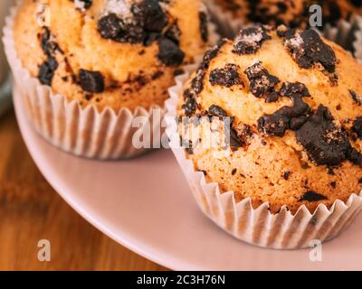 Schokoladenmuffins mit Milch. Tapete von Lebensmitteln mit Kopierraum und selektivem Fokus. Stockfoto