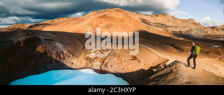 Schöne Panoramablick auf idyllische geothermische Berglandschaft am Vulkan Askja mit weiblichen Wanderer Blick auf Viti vulkanischen See in der Mitte h Stockfoto