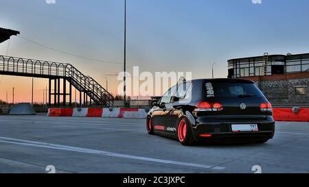 Sankt Petersburg. Winter 2018. Schwarzer volkswagen Golf mit pinken Felgen auf der Straße zwischen den Städten abgestimmt. Vor dem Hintergrund des Checkpoints, Sonnenuntergang und Staus. Stockfoto