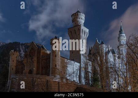 Fantastische Nacht Außenansicht des berühmten Schloss Neuschwanstein im Winter, mit blauem Sternenhimmel, Wolke, Sternen, Mondlicht und schneebedeckten Moun Stockfoto