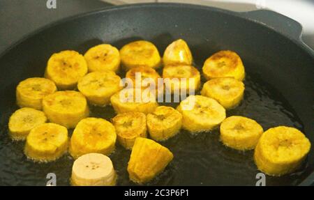 Patacone oder Tostones sind frittierte grüne Kochbananen Scheiben, in der Pfanne Stockfoto