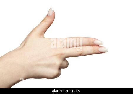 Weibliche Hand mit Frau professionelle natürliche perfekte französisch Nägel Maniküre auf weißem Hintergrund isoliert. Finger in Form einer Pistole. Stockfoto