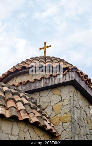 Kleine Kirche mit roten Fliesen und blauem Himmel. Stockfoto