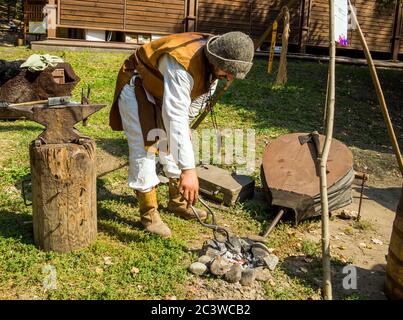 Voronesch, Russland - 05. September 2019: Ein Schmied in einer Straßenschmiede zeigt den Prozess des Schmiedens von Metall Stockfoto