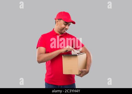 Delivery Man Mit Tablet-Aufbewahrungsbox. Indische Lieferung Junge Tablet. Home Delivery-Technologie Stockfoto