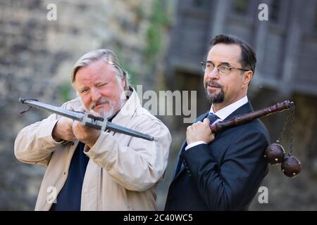 Grevenbroich, Deutschland. Juni 2020. Jan Josef Liefers (r), Schauspieler, (als Karl-Friedrich Boerne) mit einem Morgenstern mit zwei Metallkugeln und Axel Prahl, Schauspieler, (als Frank Thiel) mit Armbrust, stehen bei den Dreharbeiten zum neuen Münsteraner Tatort vor Schloss Hülchrath. Ein Sendetermin für den Tatort mit dem Titel "lang lebe der König" in der ARD ist noch nicht festgelegt. Quelle: Rolf Vennenbernd/dpa/Alamy Live News Stockfoto