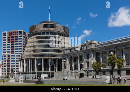 Wellington, Neuseeland: Die 'Beehive' (links) ist der gebräuchliche Name für den Exekutivflügel des neuseeländischen Parlamentsgebäudes (rechts) Stockfoto