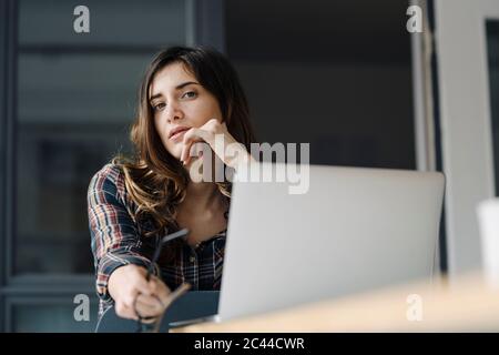 Porträt eines nachdenklichen jungen Freiberuflers in einem Loft Stockfoto