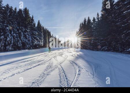 Deutschland, Bayern, Reit im Winkl, Backpacker-Frauen beim Skifahren im Winterwald bei Sonnenaufgang Stockfoto