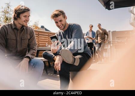 Junge Geschäftsleute treffen sich auf einer Dachterrasse Stockfoto