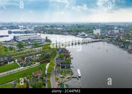 Niederlande, Nord-Holland, Zaandam, Luftaufnahme der historischen Häuser in Zaanse Schans mit Brücke über den Zaan Fluss im Hintergrund Stockfoto