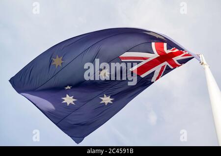 Von unten auf eine australische Flagge blicken, die auf einem Fahnenmast fliegt Stockfoto