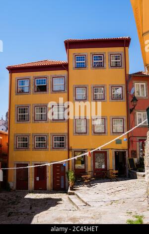 Porto, Portugal - kleiner gepflasterter Platz mit traditionellen bunten Häusern mit beliebten Heiligen Dekorationen Stockfoto