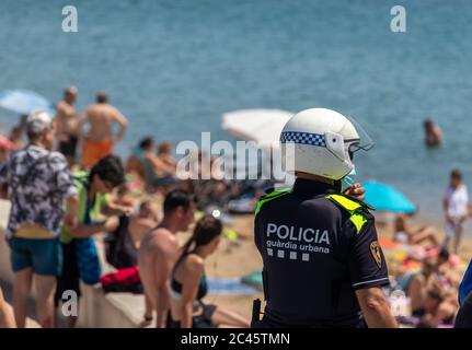 Barcelona, Spanien. Juni 2020. Polizist patrouilliert an einem Strand in Barcelona während des Sant Juan Festes. Nach mehr als 3 Monaten Absperrung in Spanien gehen in der sogenannten 'Nuw Normalität' massiv Leute an den Strand. Pflichtnachweis: Dino Geromella / Alamy Live News Credit: Dino Geromella/Alamy Live News Stockfoto