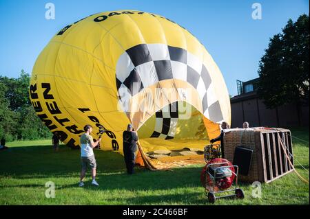 Cloppenburg, Deutschland. Juni 2020. Der Heißluftballon, von dem die Band 'Crackerjacks' ein Ballonkonzert über die Stadt Cloppenburg geplant hat, wird auf die Fahrt auf einer Wiese vorbereitet. Kredit: Mohssen Assanimoghaddam/dpa/Alamy Live Nachrichten Stockfoto