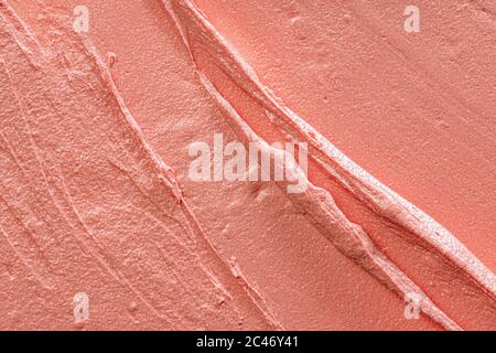 Hintergrund eines glänzenden verschmiert Pfirsich Farbe Lippenstift Stockfoto