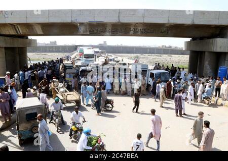Die Bewohner der Lyari Meera Naka Block Straße, während sie Protestdemonstration gegen Verlängerung der Stromlast in ihrem Gebiet, in Mirza Adam Khan Straße in Karachi am Mittwoch, 24. Juni 2020 statt. Stockfoto