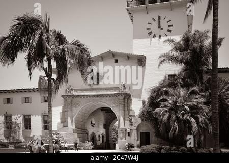 Menschen um das Wahrzeichen, Santa Barbara County Courthouse Eingang und Blick durch den Säulenbogen Eingang zu den Gärten in Santa Barbara, CA, Stockfoto