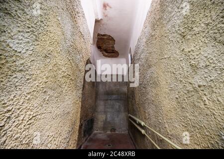 24. Juni 2020, Brandenburg, Potsdam: Die Wände einer einzelnen Zelle des ehemaligen Geheimdienstgefängnisses im Ausstellungsbereich der Gedenkstätte und des Versammlungsgeländes Leistikowstraße sind mit grobem Putz bedeckt, so dass die Gefangenen sich nicht daran lehnen und Botschaften schnitzen können. Bis zur Auflösung des KGB 1991 wurden hier im Zentrum der sowjetischen "Militärstadt Nr. 7" Tausende Männer und Frauen festgehalten. In der ersten Nachkriegszeit wurden auch Deutsche inhaftiert, später nur sowjetisches Militär und Zivilisten. Im ehemaligen Zentralgefängnis der sowjetischen Militärspionage entschäfen Stockfoto