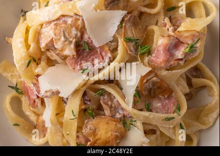 Nahaufnahme Food Hintergrund Pasta Fettuccine mit Pilzen, Speck und Parmesan Käse Stockfoto