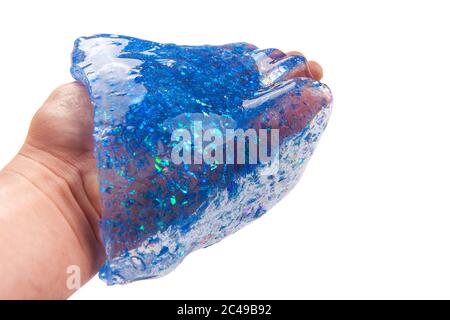 Hand hält einen blauen Glitzer Schleim isoliert auf weißem Hintergrund. Stockfoto