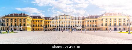 WIEN, ÖSTERREICH - 23. JULI 2019: Schloss Schönbrunn, Deutsch: Schloss Schönbrun, barocke Sommerresidenz der Habsburger Monarchen in Hietzing, Wien, Österreich. Panoramablick auf die Fassade vom Haupthof. Stockfoto