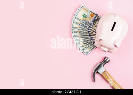 Sparschwein und Bargeld einhundert Dollar-Rechnungen auf rosa Hintergrund. Flaches Lay, Draufsicht, Overhead, Mockup, Schablone Stockfoto