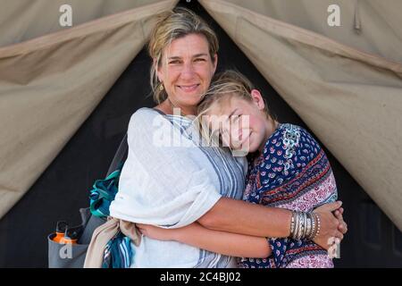 Mutter und ihre junge Tochter im Teenageralter vor einem Zelt. Stockfoto