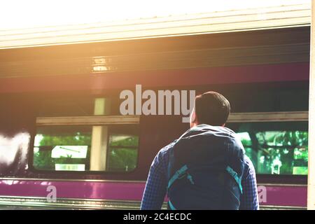 Asain Mann auf Plattform wartenden Zug stehen. Stockfoto