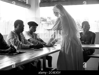 Nonne Missionary Kontrolle der Hände von jungen Männern in der Elfenbeinküste 1963 Elfenbeinküste 1960 Stockfoto