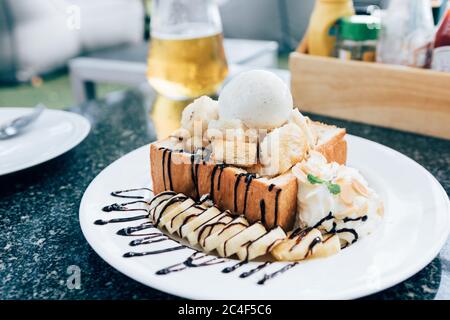 Honigtoast mit Banane und Vanilleeis. Stockfoto