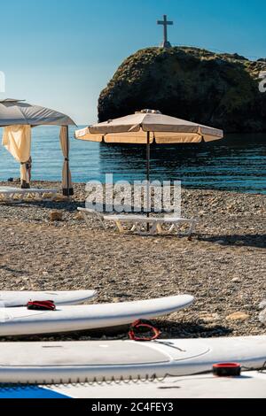 SUP-Boards in Reihe und Strandvordächer bei Sonnenaufgang, am frühen Morgen. Luxus Strandzelte im luxuriösen Strandresort. Sommer Strand Konzept, Entspannung und Stockfoto