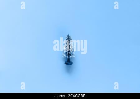 Miniatur Modell Winter Kiefer mit Schnee ist Requisiten Dekoration auf blauem Hintergrund Stockfoto