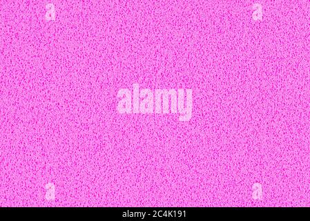 Ein Makrofoto mit einem rosa Farbverlauf mit Textur aus echtem Schaumstoff-Schwammpapier für Hintergrund, Hintergrund oder Design. Stockfoto