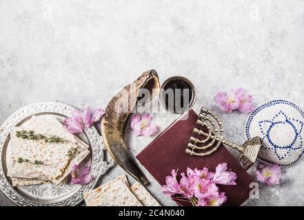 Metallplatte mit Matzah oder Matza, Kiddusch Cup, Shofar Horn auf einem hellen Hintergrund als Passahseder Fest oder Mahlzeit mit Kopierraum präsentiert. Jüdisch Stockfoto