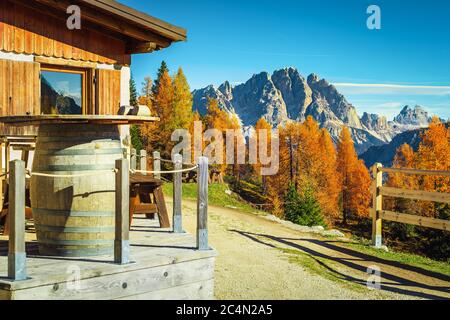 Gemütliche Unterkunft mit Holzhaus in den Bergen. Traumhafte Erholungs- und Wanderlage im bunten Herbstwald, Dolomiten, Italien, Stockfoto